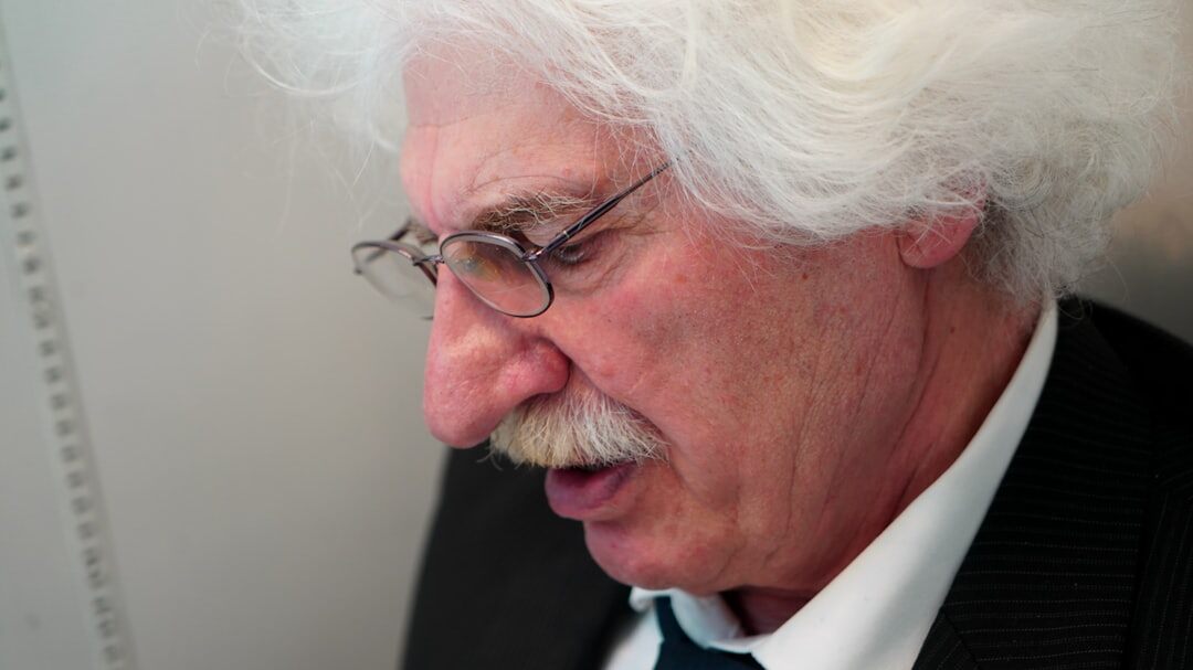 Portrait of a man expert with gray hair and suit